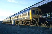 Setting winter sun highlights a Class 101 DMU standing at the terminus at Felixstowe in December 1985. The cab is fitted with an aerial for RETB working on the East Suffolk line.<br><br>[Mark Dufton /12/1985]