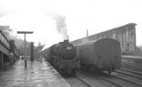 A grey morning at Carlisle on 31 July 1965 with the summer Saturday 0945 Blackpool North - Glasgow Central recently arrived at platform 1 behind Crewe South Black 5 no 44715. [See image 50263].  <br><br>[K A Gray 31/07/1965]