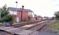 Approaching Bedlington station from the Morpeth direction in May 2004. On the left is Bedlington North signal box, with the platform and station building straight ahead. The Ashington route runs past the other side of the box.<br><br>[John Furnevel 25/05/2004]