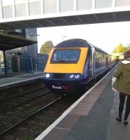 Old and new at St. Austell: the mothballed signal box can just be seen over the young lady's shoulder as an up HST pulls in on 29th November. The new footbridge is almost ready for use.<br><br>[Ken Strachan 29/11/2014]