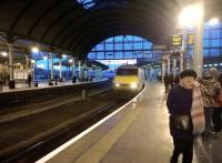 A strong contender for 'scarf of the year' can be seen to the right as a down East Coast service arrives at Newcastle a few days before Christmas 2014. The overall roof is especially impressive at dusk.<br><br>[Ken Strachan 20/12/2014]
