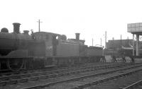 Scene in the yard at Bathgate on a gloomy 28 March 1964. By this time many of the locomotives occupying the yard were stored awaiting disposal, including Holmes NB J83 0-6-0T 68477 which had been withdrawn from St Margarets at the end of 1962. In the background in front of the shed J36 and B1 locomotives are in steam.<br><br>[K A Gray 28/03/1964]
