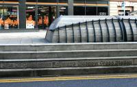 Little noticed by passing traffic and busy pedestrians, this inscription in the south face of the plinth covering the location of the former Glasgow Cross station is the only clue to the purpose of this rather odd feature in the middle of the Trongate at Glasgow Cross. [See image 50198]<br><br>[Colin McDonald 31/01/2015]