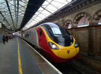 Not a particularly mellow yellow. The 10.09 to Glasgow Central pulls into platform 11 at Crewe on a wet Wednesday (the snow came later). At least the platform was dry this time [see image 33154]<br><br>[Ken Strachan 28/01/2015]