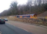 Looking across the A7 Ladhope Vale, Galashiels, on 3 February 2015 as the tracklaying train continues to make steady progress south towards Tweedbank.<br><br>[John Yellowlees 03/02/2015]