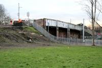 Contractors at work on 5 February 2015 sealing off the overbridge which carries Old Mill Road across both the West Coast main line and the Kirkhill line at Cambuslang. The bridge has had a weight limit in place for some time and is to be replaced with a new concrete structure. The work is scheduled for completion by the autumn of 2015.<br><br>[Colin McDonald 05/02/2015]