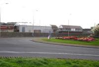 View across the A55 roundabout on the approach to Holyhead Port in October 2012. On the right is the signal box, with the Arriva Trains Wales two road TMD servicing shed on the left. [See image 40339]<br><br>[David Pesterfield 02/10/2012]
