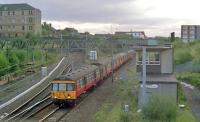 A westbound train passes Bellgrove Junction in 1987. The (then) recently modified junction, featuring a single lead on the Springburn line, can be seen to the left.<br><br>[Ewan Crawford //1987]