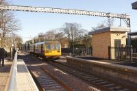 A Liverpool to Warrington service departs from platform 3 at Huyton on 3 February 2015. Photographed from platform 4, which is not yet usable as there is a vital component missing to the east of the station. Purchase of a small strip of land is to be finalised by Network Rail if Plan A is going to work.<br><br>[John McIntyre 03/02/2015]