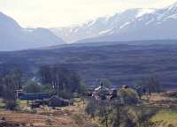 Mid-day Mossend-Fort William freights cross at Rannoch in 1991. A camping coach sits grounded on the site of the lifted siding to the left of the station.<br><br>[Ewan Crawford //1991]