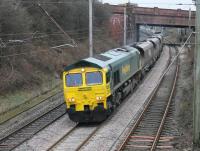 With a bright yellow front end that was in marked contrast to the rest of the paintwork, Freightliner 66524 works empty hoppers from Fiddlers Ferry to Hunterston through Hest Bank on 10th February 2015.<br><br>[Mark Bartlett 10/02/2015]