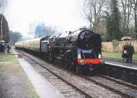 92220 <I>Evening Star</I>, bringing a train into Crowcombe Heathfield Station on the West Somerset Railway, during a shower of rain on 19 March 1989.<br><br>[Peter Todd 19/03/1989]