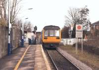A Blackpool South to Colne service departs from Moss-Side station on 2 February 2015. The level crossing sequence is initiated by depressing a plunger on the platform before the train departs. In the other direction the sequence is initiated by a wheel flange depressing a treadle on the approach, like most AHB crossings.<br><br>[John McIntyre 02/02/2015]