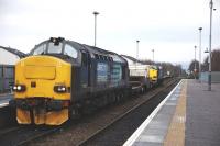 DRS 37259 + 37607 trundle through Muir of Ord on 11 February 2015 with the northbound nuclear flask special for Georgemas Junction.<br><br>[John Gray 11/02/2015]