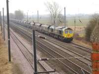 Freightliner 66588 on the northbound slow line at Overton Lane overbridge near Beningbrough on 12 February with a rake of empty coal wagons.<br><br>[David Pesterfield 12/02/2015]