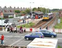 Northern Pacer unit 142067, forming the 1142 Saltburn - Darlington service, pulls up alongside platform 1 at Redcar Central station on 5 June 2013, just as the level crossing gates reopen on West Dyke Road.<br><br>[John Furnevel 05/06/2013]