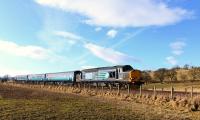 37602 with three DRS liveried coaches in tow heads for Wick from Inverness on 12 February 2015. It appears to have been a recovery train of some sort, on its way to collect a coach from a test train that had developed a fault. <br><br>[John Gray 12/02/2015]