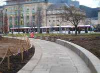 Edinburgh tram 274 photographed from St Andrew Square Gardens on 11 February alongside the adjacent tram stop on its way to York Place terminus.<br><br>[David Pesterfield 11/02/2015]
