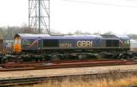 GBRf locomotive 66724 <I>Drax Power Station</I> seemingly hemmed in by wheel sets and container waggons in the sidings at Peterborough on 10th February 2015.<br><br>[Colin McDonald 10/02/2015]