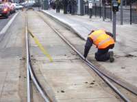 Cleaning out debris affecting the operation of the normally spring loaded points at the west end of York Place tram stop taking place during the afternoon of 11 February. The yellow lever is used to manually move the points between tram movements at the stop.   <br><br>[David Pesterfield 11/02/2015]