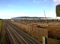 The line of trees that previously stood in the background [see image 35428] seems to have been sacrificed to build DIRFT 3. View north west on 18 February 2015 with Rugby station just off the end of the 'Northampton loop' in the left background.<br><br>[Ken Strachan 18/02/2015]