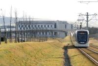 With an afternoon mist hanging over the Pentland Hills in the background, a city bound tram runs south from Edinburgh Park Central towards the E&G flyover on 18 February 2015.   <br><br>[John Furnevel 18/02/2015]