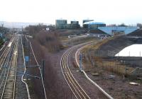 To the left the lines run south into Millerhill yard while on the right the Borders Railway turns towards Shawfair. Between is the slightly alien landscape that now dominates this part of the old down yard. The buildings and tanks are part of the under construction food waste recyling (anaerobic digestion) plant which will serve Edinburgh and Midlothian. Scene early on Sunday 1 March 2015.<br><br>[John Furnevel 01/03/2015]