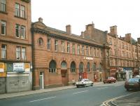 The frontage of the former Bridgeton Central station in November 1997, then in use as a bookmaker and looking fairly unadorned compared with today. The pub next door was called The Windsor, but is now, in a bit of retrospective renaming, it's The Station Bar. The then empty premises on the left is now a beauty salon. [See image 33717]<br>
<br><br>[David Panton 25/11/1997]