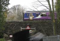 156490 leaves Carnforth heading for Barrow-in-Furness. The train has just passed the West Coast depot and is now on the bridge crossing Crag Bank Road and the tidal River Keer. [Ref query 7588]<br><br>[Mark Bartlett 27/02/2015]