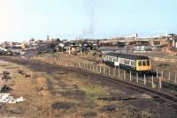 Southport, on the occasion of a 1982 open day at the Steamport preservation centre, with a Derby 108 DMU and Class 03 shunter being used on shuttles to and from Chapel St station which is just visible on the left of the picture. Moving across from left to right the still operational coal concentration depot can be seen and then the old steam shed, with BR Type 2 24081 visible. Above the DMU work has started on a supermarket on the site of the old Southport Central station. This had closed to passengers in 1901 but served as a goods depot until 1973 and had not long been demolished when this photograph was taken [See image 57567]  <br><br>[Mark Bartlett 11/09/1982]