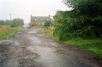 Until fairly recently a former level crossing on the Arniston Coal Company's railway was still visible on Engine Road, Gorebridge. Further damage to the tarmac was to reveal there were at least two tracks, but these are now either removed or buried. View east in 2002, with the site of Newbyres Pit and Arniston Engine Pit off to the left and the Emily Pit and Gore Pit to the right.<br><br>[Ewan Crawford //2002]