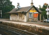 In July 1998 the blank face of the Busby station building, which then housed a Chinese take-away, looked rather shabby. Today things are a little better. In case you are wondering, that odd-looking thing top right is the sleeve of a litter bin, placed there by idle hands to rest on the head of the platform lighting.<br>
<br><br>[David Panton 17/07/1998]