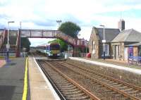 An exceptionally hot day at Barry Links looking south in August 2006 with an Aberdeen bound express service on the level crossing. The up platform was part of an island with the south side once used by troop trains serving the nearby MoD Barry Buddon training camp [see image 49155].<br><br>[John Furnevel 13/08/2006]