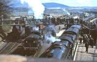 A busy scene at Newton Stewart on 15 April 1963 with Jubilee 45588 <I>Kashmir</I> preparing to leave with <I>'Scottish Rambler No 2'</I> for Stranraer Town. In the centre Caley 'Jumbo' 57375 has recently returned with the special from visits to Whithorn and Garlieston. Over on the left Ivatt 2-6-0 46467 is standby locomotive, while in the background a Black 5 has halted in the loop with an eastbound freight.<br><br>[John Robin 15/04/1963]