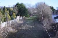 A section of the Glasgow, Bothwell, Hamilton and Coatbridge Railway trackbed survives in the middle of housing in Mount Vernon in 2015, with a culvert for the Tollcross burn halfway along its length. Notable for its use in the recent past for exercising horses, this remnant of the line can be seen from the former Sandyhills Road overbridge (now infilled).<br><br>[Colin McDonald 10/03/2015]