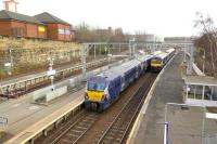 There are two reversals in three minutes in the through platforms at Springburn as 320307 departs for Dalmuir on 5 March, whilst 334024 waits for the route to be set for its journey to Cumbernauld.  Electrification of the route via Stepps has left the bay platforms at Springburn in use at peak times only.<br><br>[Malcolm Chattwood 05/03/2015]