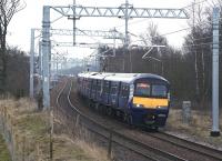 320321 on a Whifflet - Milngavie service passing the site of Tannochside Junction on 12 March 2015. The orange hi-viz jackets of construction workers building the M8 Braehead railway viaduct can just be seen in the left background.<br><br>[Colin McDonald 12/03/2015]