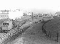 Ex-Caledonian 0-6-0 57557 propelling a brakevan north along the Switchback on 28 May 1958. The combination has just passed below the A80 in the background with Kennyhill goods on the right. [Ref query 4430]<br><br>[G H Robin collection by courtesy of the Mitchell Library, Glasgow 28/05/1958]