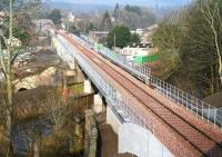 The rail route north out of Galashiels on 18 March 2015. View is from the new footbridge on Plumtreehall Brae towards the former Kilnknowe Junction.  After crossing the Gala Water the line then passes over Wheatlands Road before running below the bridge at Kilnknowe Place in the background. [See image 41622]<br><br>[John Furnevel 18/03/2015]