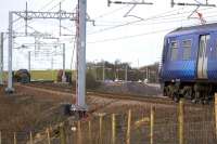 320305 slowly approaches the Cutty Sark bridge form the Bargeddie side on 23rd March 2015. Construction works for the new viaduct over the M8 extension can be seen beyond the bridge.<br><br>[Colin McDonald 23/03/2015]