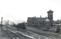 Black 5 no 45007 passing Ardrossan North on 5 July 1959 with a train for Montgomerie Pier. The train has just passed the large Shell refinery in the left background. Ardrossan North station had been closed since 1932, although Montgomerie Pier survived until 1967. The refinery closed in 1986. [See image 23867]<br><br>[G H Robin collection by courtesy of the Mitchell Library, Glasgow 05/07/1959]