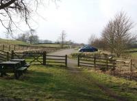 Looking north-west over the site of Mickleton station on the former Middleton-in-Teesdale branch on 19 March 2015. The station was where the cars are parked with the track running along the left side of the car park. [Ref query 4442]<br><br>[John McIntyre 19/03/2015]