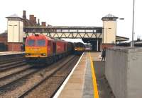 60100 idles on the centre road at Hereford on 30 March 2015 with a Margam-bound steel train. 150109 has recently arrived alongside with a service from Birmingham New Street. The HST just visible on the far right will shortly leave for Paddington. Notice the new lift towers at each end of the footbridge [see image 32779] - these are not in service just yet.<br><br>[Ken Strachan 30/03/2015]