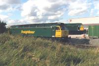 Freightliner 47150 and 47258 stabled at the east end of Stourton Freightliner Terminal, Leeds, in 1999. The former stands on one of the terminal tracks and the latter on a spur that ran alongside Valley Farm Road to service a steel stockholding warehouse. The link into the warehouse is no more, and the spur to the right has long been out of use.<br><br>[David Pesterfield //1999]