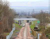 The line south through Eskank (new) on 27 March 2015. The whole area has been tidied up considerably since the last visit. Just beyond the station the line swings left onto the bridge over Hardengreen roundabout. [See image 49218]<br><br>[John Furnevel 27/03/2015]