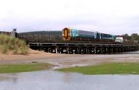 A Class 158 DMU from Pwllhei crosses the now demolished Pont Briwet wooden trestle bridge on a rainy day in October 2012.<br>
The railway now crosses the River Dwyryd on a concrete bridge on a new parallel alignment, while a separate road bridge is nearing completion (April 2015) on the site of the former trestle bridge. [See image 49098] <br><br>[Colin McDonald /10/2012]