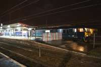 A cross-platform view of the Serco operated Caledonian Sleeper at Preston in the early hours of 1 April 2015 [see image 50831]. Of note was the fact that the train was routed into platform 1 rather than the usual platform 4 due to a coal train from Hunterston to Fiddlers Ferry Power Station having been brought to a stand fouling the south end of platform 4 with a serious wheelflat on the first wagon.<br><br>[John McIntyre 01/04/2015]