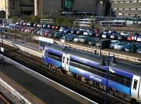 A harsh morning sun illuminates the 0923 ScotRail service to Glasgow Queen Street awaiting its departure time in bay platform 7 at Stirling station on 1 April 2015. <br><br>[John Furnevel 01/04/2015]