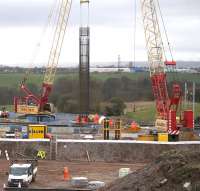 One of the prefabricated steel reinforcements is lowered into place at the Braehead viaduct construction site during the weekend line closure on 4th April 2015.  This will form one of the four main supporting columns for the viaduct [see image 46140: lower picture].<br><br>[Colin McDonald 04/04/2015]