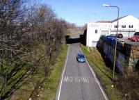 Course of the CR main line into Edinburgh, looking towards Princes Street station from Dundee Terrace in April 2015. Dalry Road shed was under that bridge and hard to the left. The building on the right was rail served, and sleeper traces can still be seen.<br>
<br><br>[David Panton 05/04/2015]